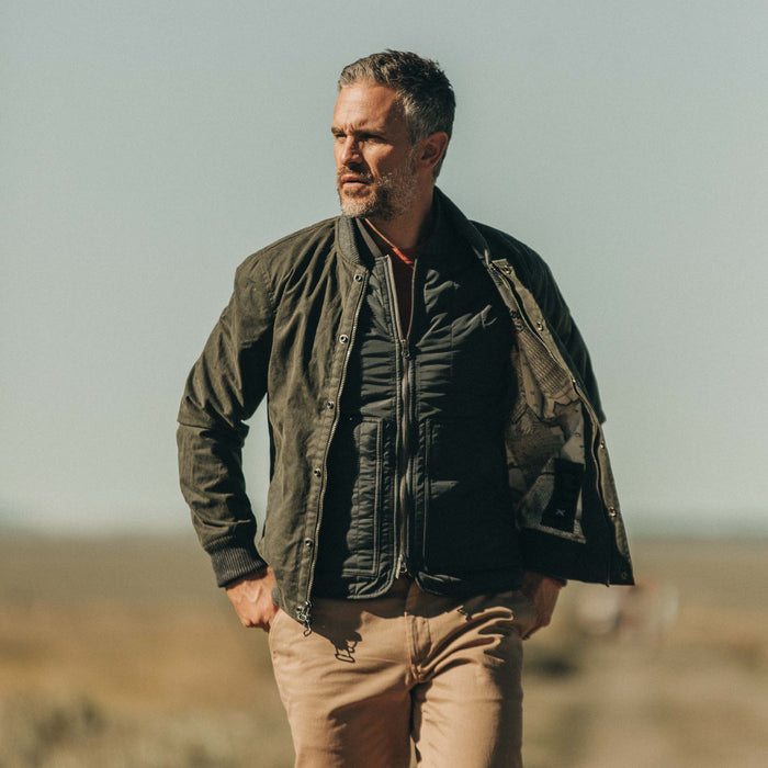 fit model wearing The Bomber Jacket in Waxed Olive open over a vest