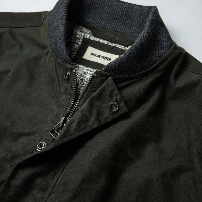 material shot of The Bomber Jacket in Waxed Olive from the front showing label and collar