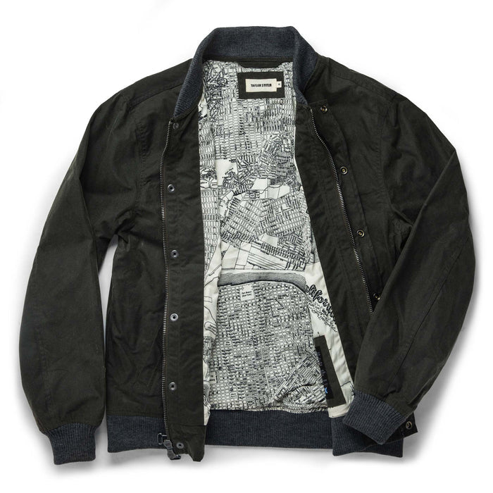 flatlay of The Bomber Jacket in Waxed Olive open from the front
