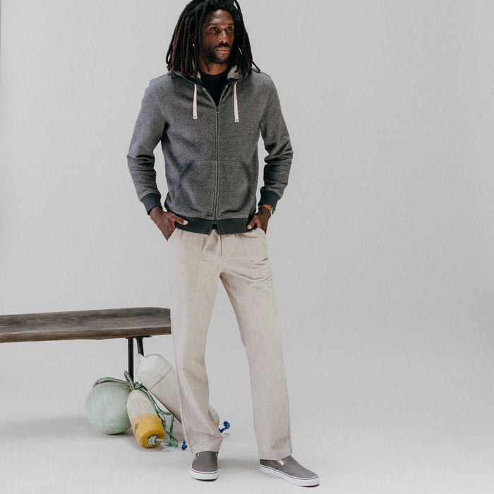 fit model posing in front of a bench wearing The Breakwater Pant in Oat Donegal