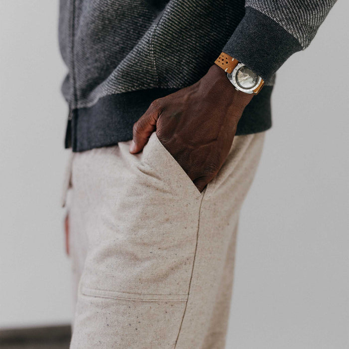 fit model with his hand in his pocket wearing The Breakwater Pant in Oat Donegal