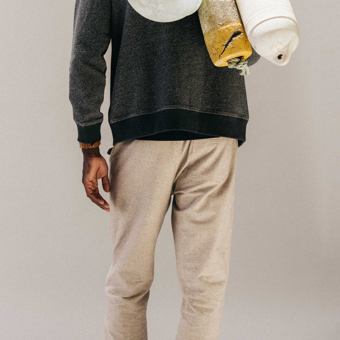 fit model walking wearing The Breakwater Pant in Oat Donegal