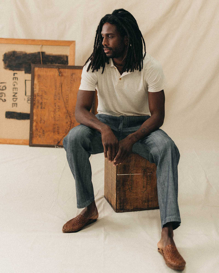 fit model sitting wearing The Breakwater Pant in Rinsed Indigo Stripe