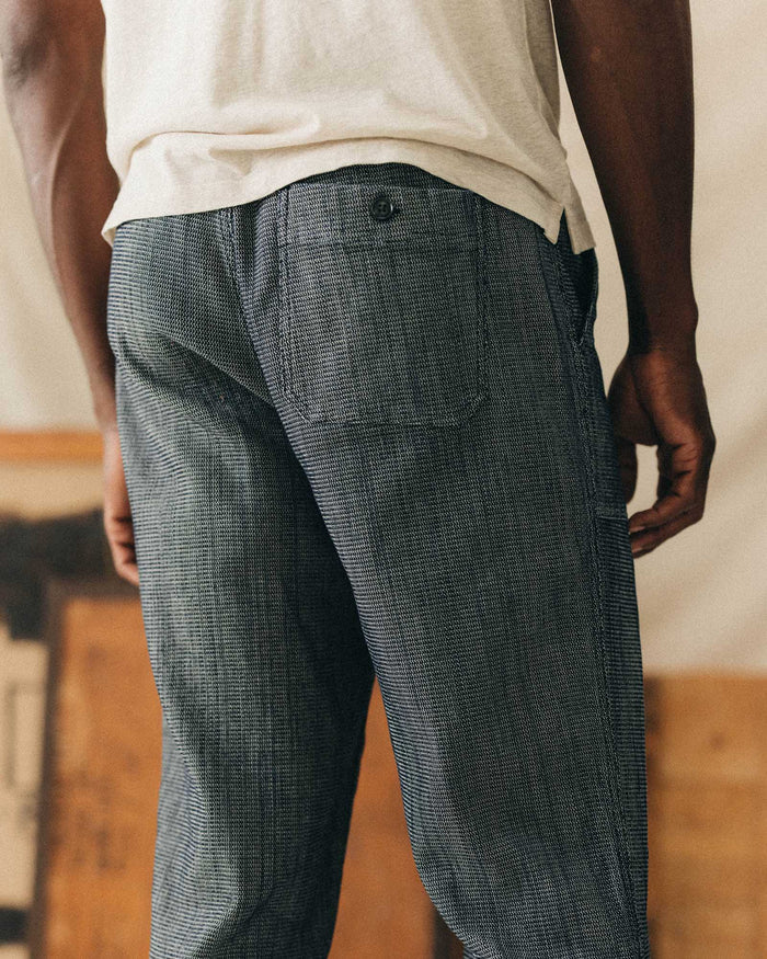 fit model showing off the back pocket on The Breakwater Pant in Rinsed Indigo Stripe