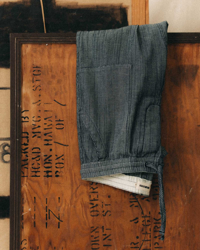 editorial image of The Breakwater Pant in Rinsed Indigo Stripe hanging
