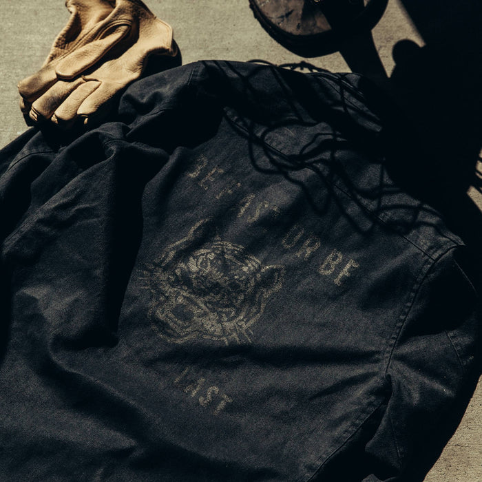 textural flatlay of The Brother Moto Lined Shop Shirt in Be Fast