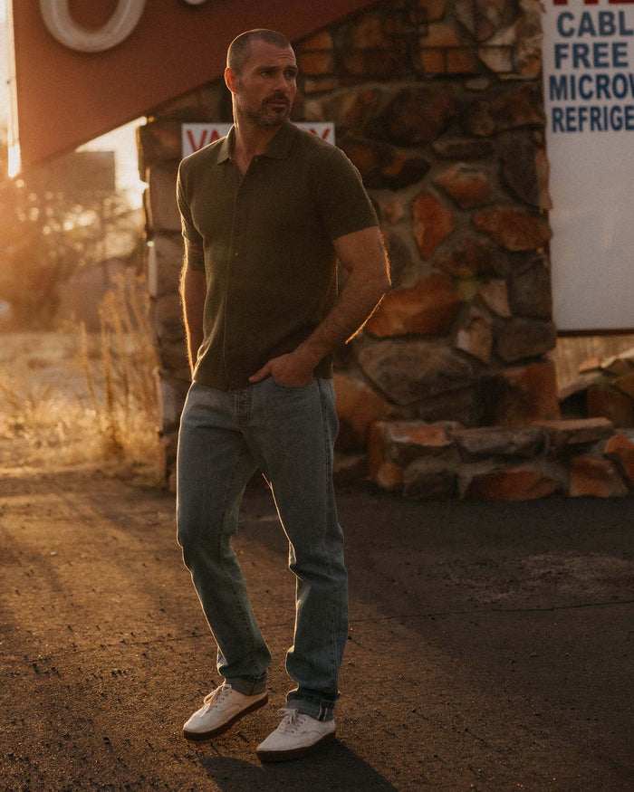 fit model walking wearing The Button Down Polo in Cilantro Herringbone