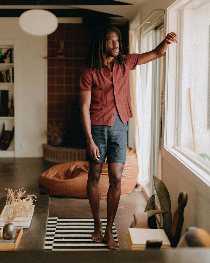 fit model showing off The Button Down Polo in Dried Cherry Stripe
