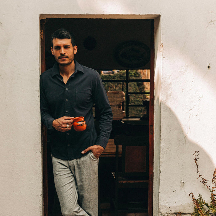 fit model wearing The California in Navy Pique, drinking coffee