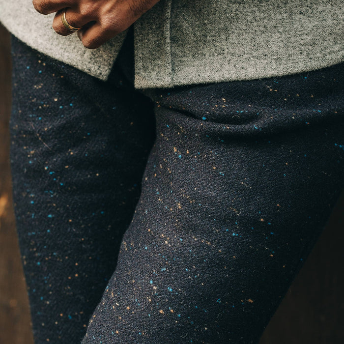 our fit model wearing The Camp Pant in Navy Donegal Herringbone—standing near shed, cropped shot