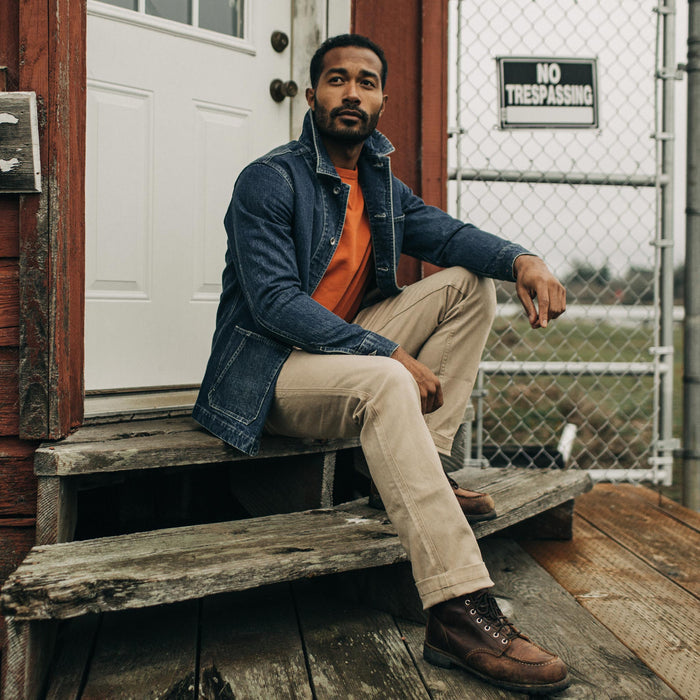 fit model posing on wooden steps in The Camp Pant in Sand Boss Duck