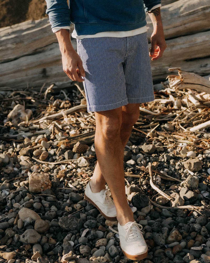 fit model walking wearing The Camp Short in Indigo Railroad Stripe Denim