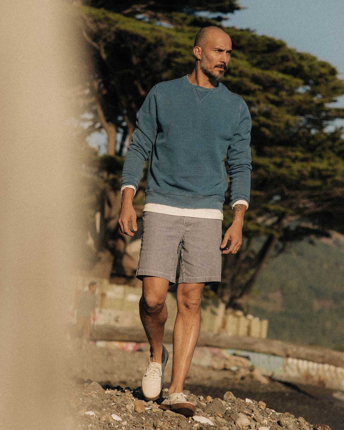 fit model walking wearing The Camp Short in Indigo Railroad Stripe Denim