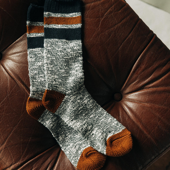 fatlay of The Camp Sock in Heather Olive on a couch
