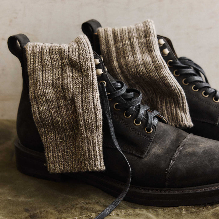 editorial image of The Camp Sock in Marled Smoked Olive in boots