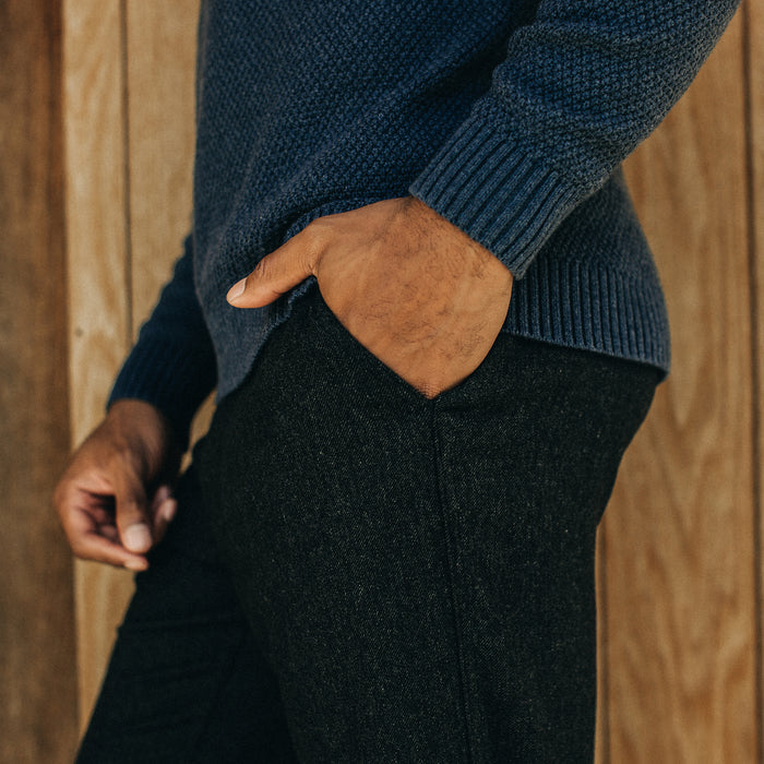 fit model with his hand in the pocket posing in The Carmel Pant in Dark Charcoal