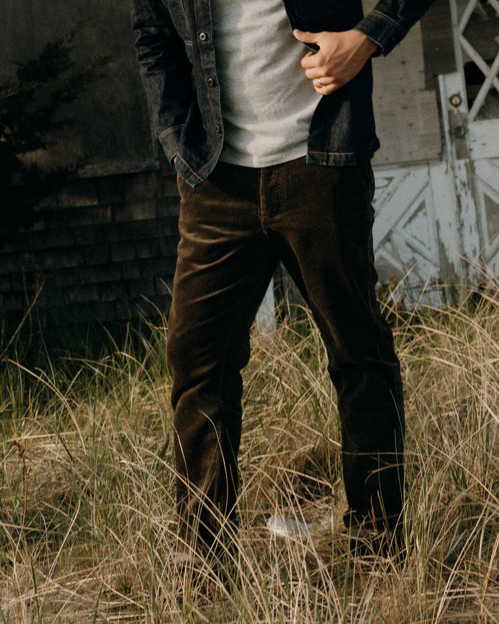 fit model posing in The Carnegie Pant in Fatigue Olive Corduroy