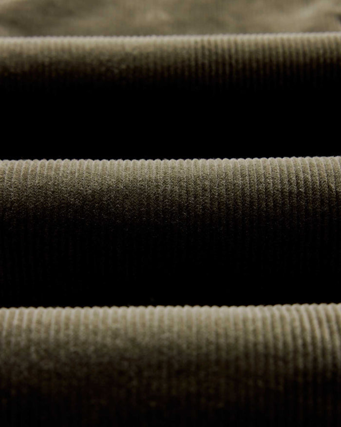 material shot of the fabric on The Carnegie Pant in Fatigue Olive Corduroy