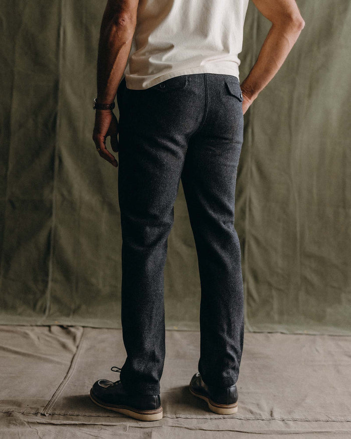 fit model with his hand in his pocket wearing The Carnegie Pant in Heather Charcoal Wool