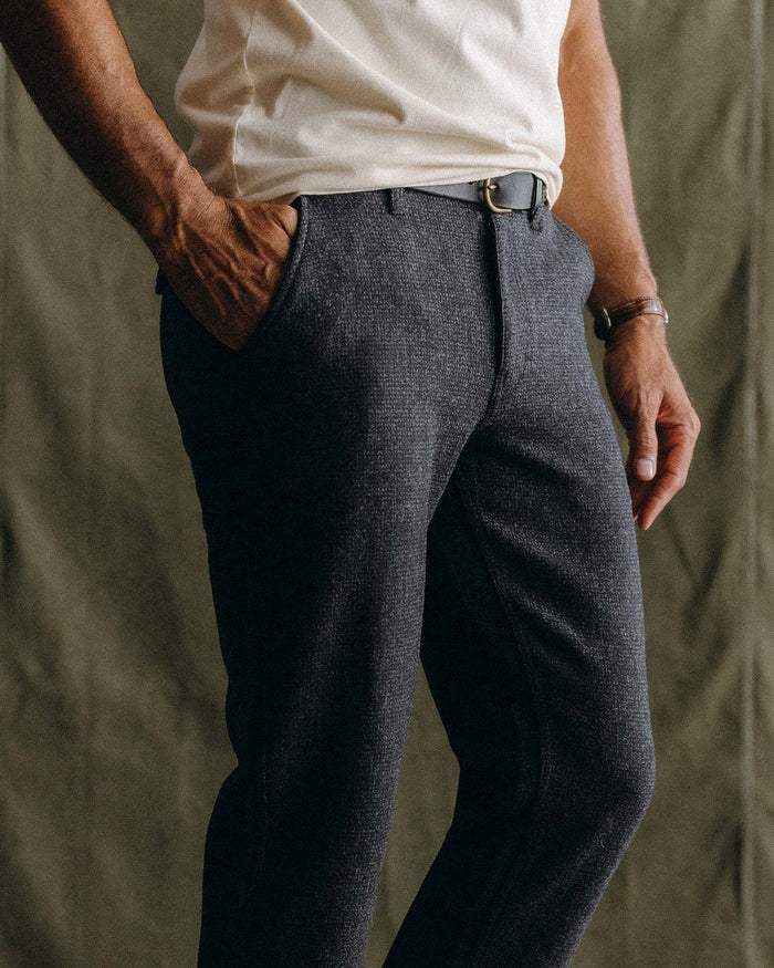 fit model sitting wearing The Carnegie Pant in Heather Charcoal Wool