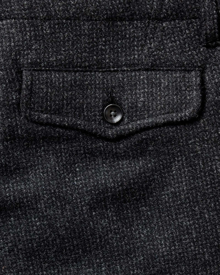 folded flatlay of the back of The Carnegie Pant in Heather Charcoal Wool