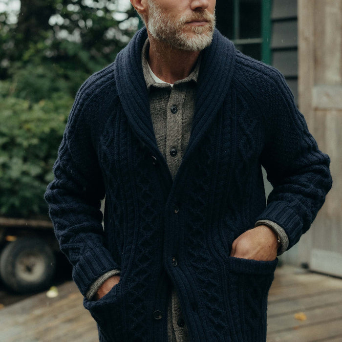 fit model with his hands in his pockets wearing The Cascade Shawl Cardigan in Heather Marine
