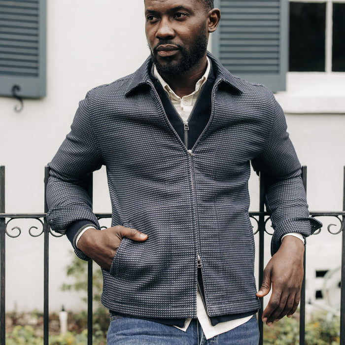 fit model with The Cavern Jacket in Navy Dobby Grid zipped up
