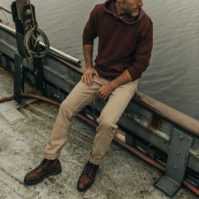 fit model sitting on the edge of a boat in The Chore Pant in Sand Boss Duck