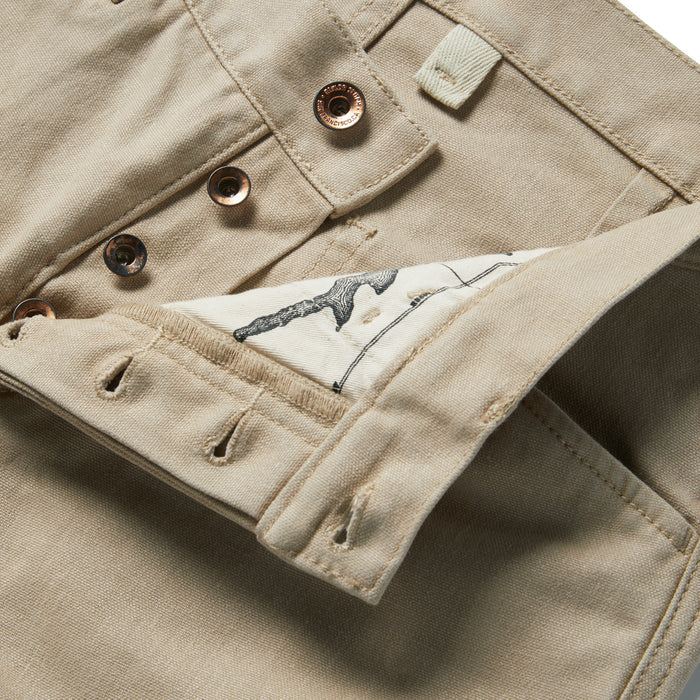 material shot of the buttons and map pocket printing on The Chore Pant in Sand Boss Duck