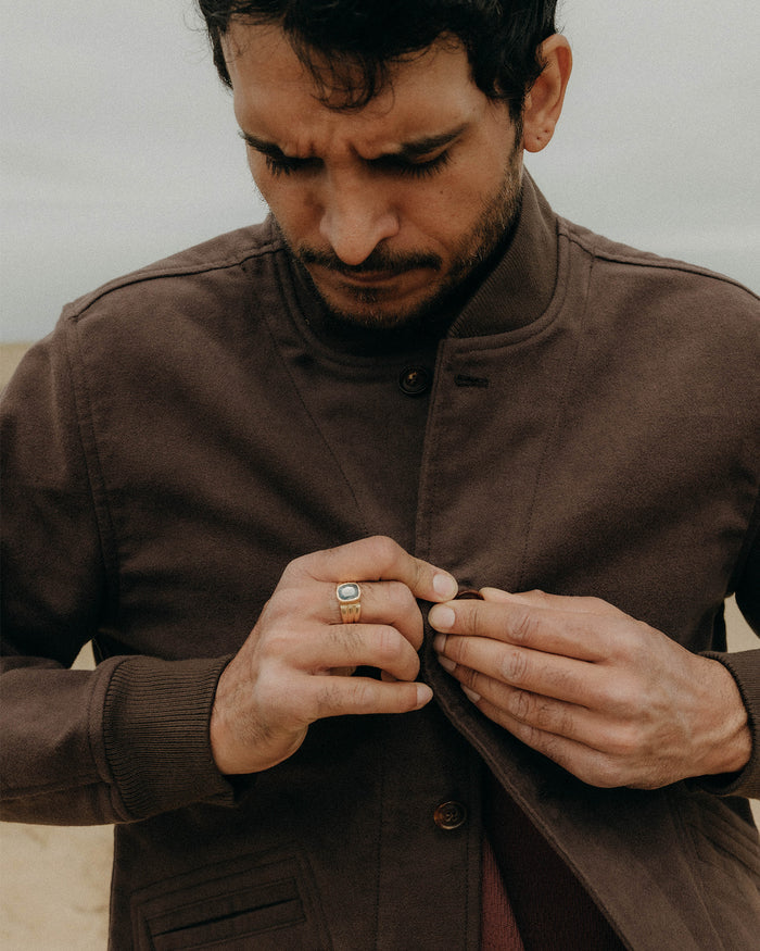 fit model buttoning up The Clark Bomber in Soil Moleskin