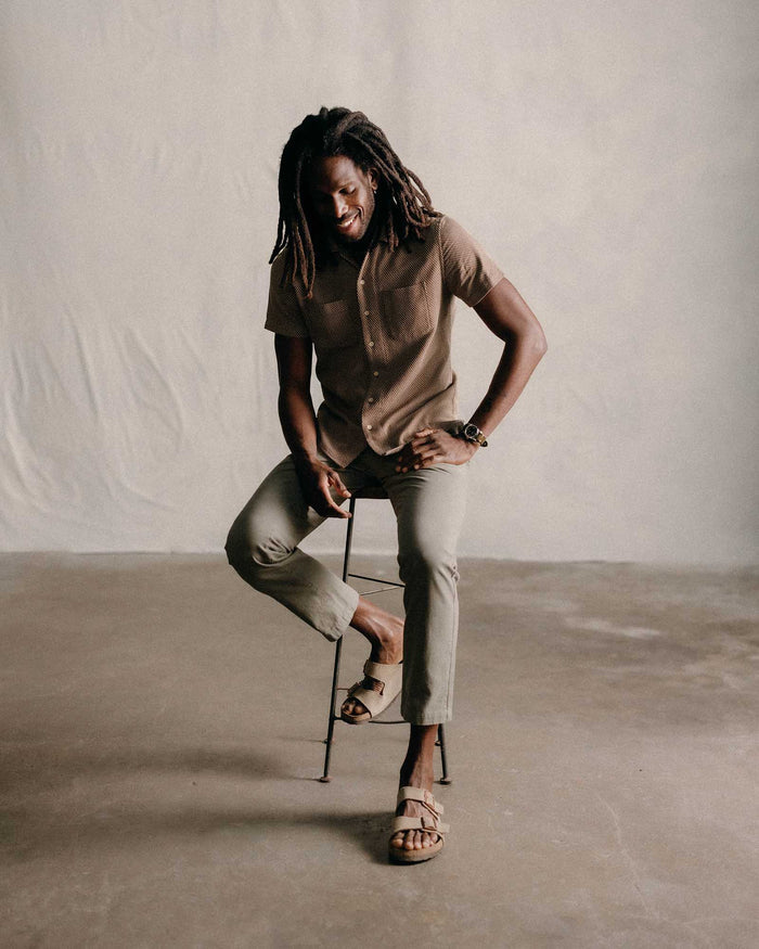 fit model sitting wearing The Conrad Shirt in Cocoa Dobby