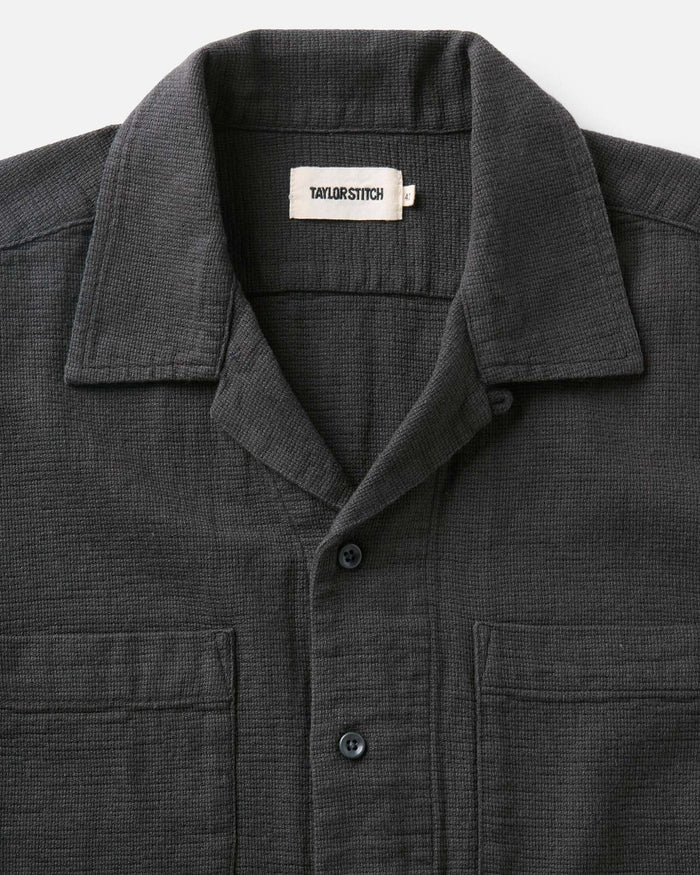 editorial image of The Conrad Shirt in Faded Black Linen hanging on a painting