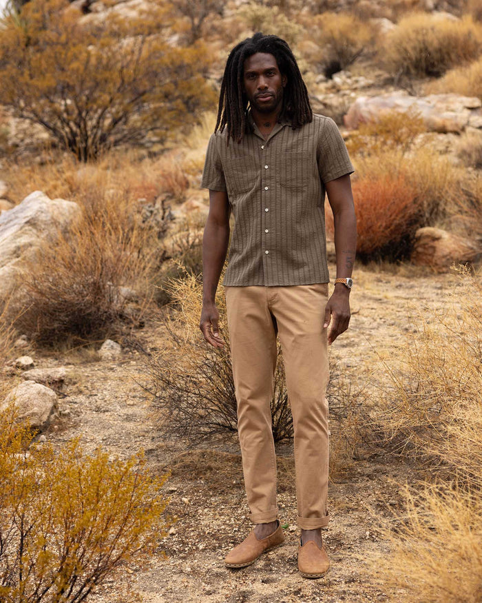 fit model posing in The Conrad Shirt in Fatigue Olive Dobby Stripe
