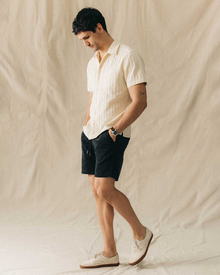 fit model walking wearing The Conrad Shirt in Vintage White Dobby Stripe