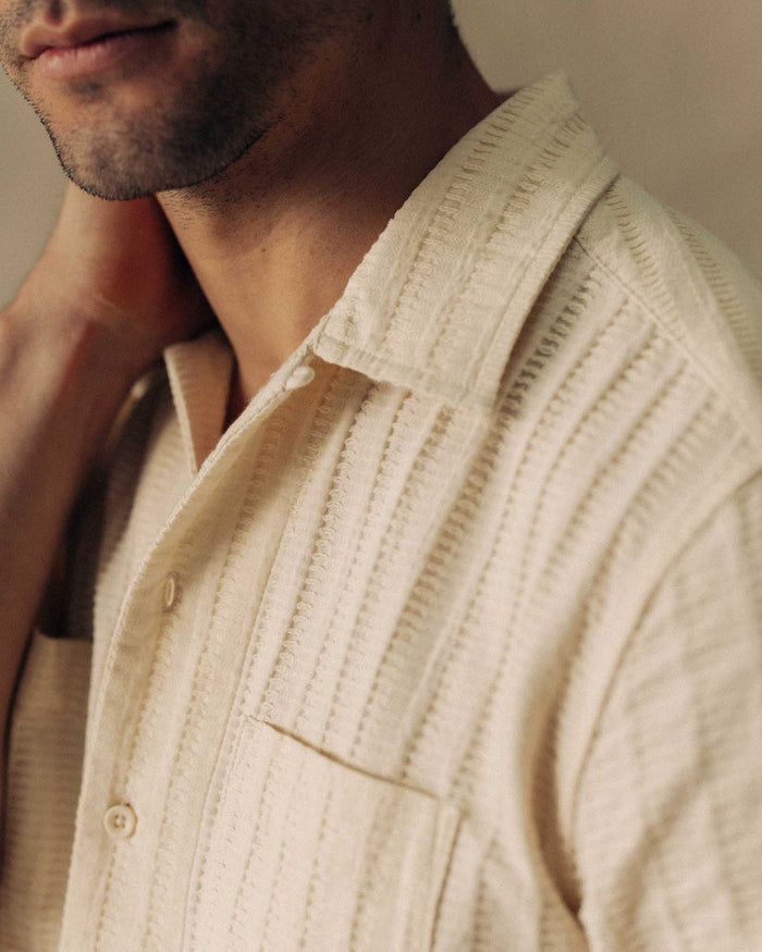 fit model showing off the fabric on The Conrad Shirt in Vintage White Dobby Stripe