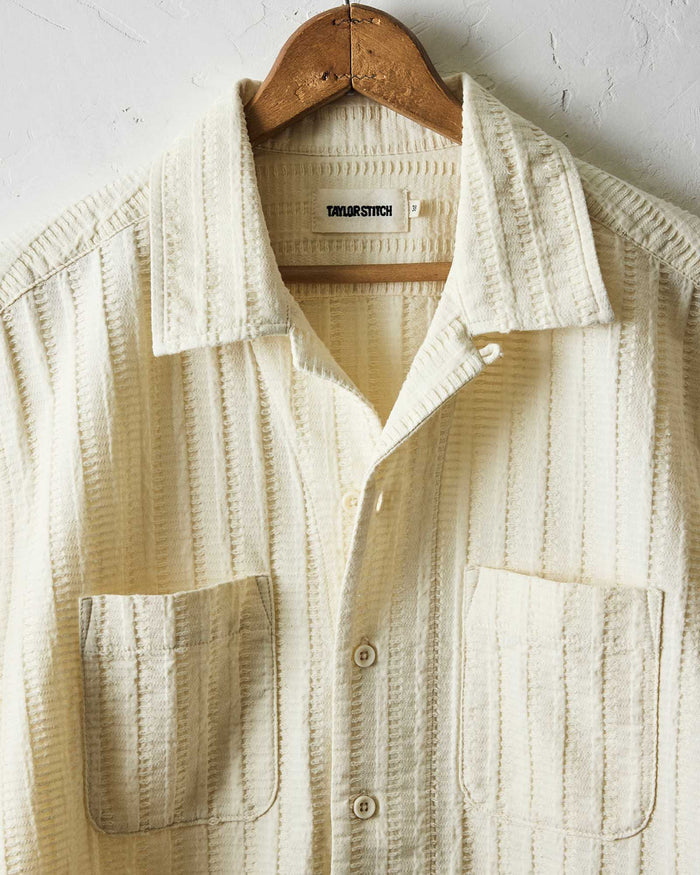 editorial image of The Conrad Shirt in Vintage White Dobby Stripe hanging