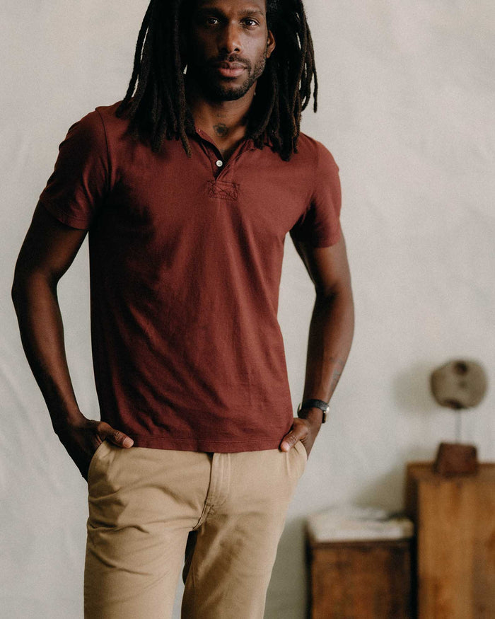 fit model with his hands in his pocket wearing The Cotton Hemp Polo in Black Cherry
