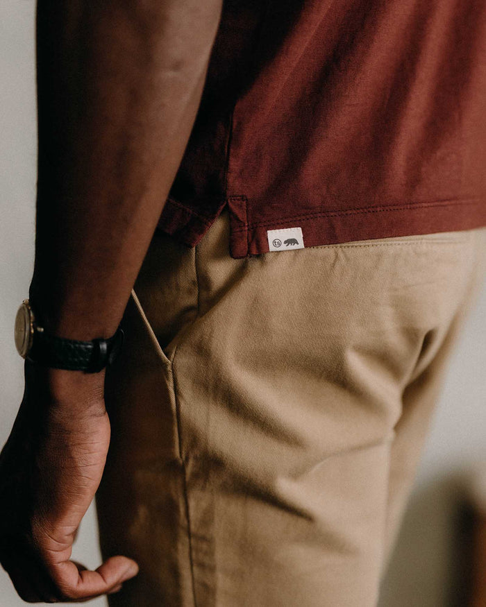 fit model showing off the hem on The Cotton Hemp Polo in Black Cherry
