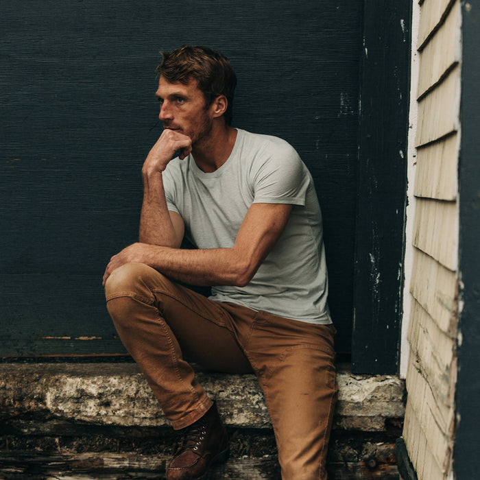 fit model wearing The Cotton Hemp Tee in Bay Mist, sitting on ledge