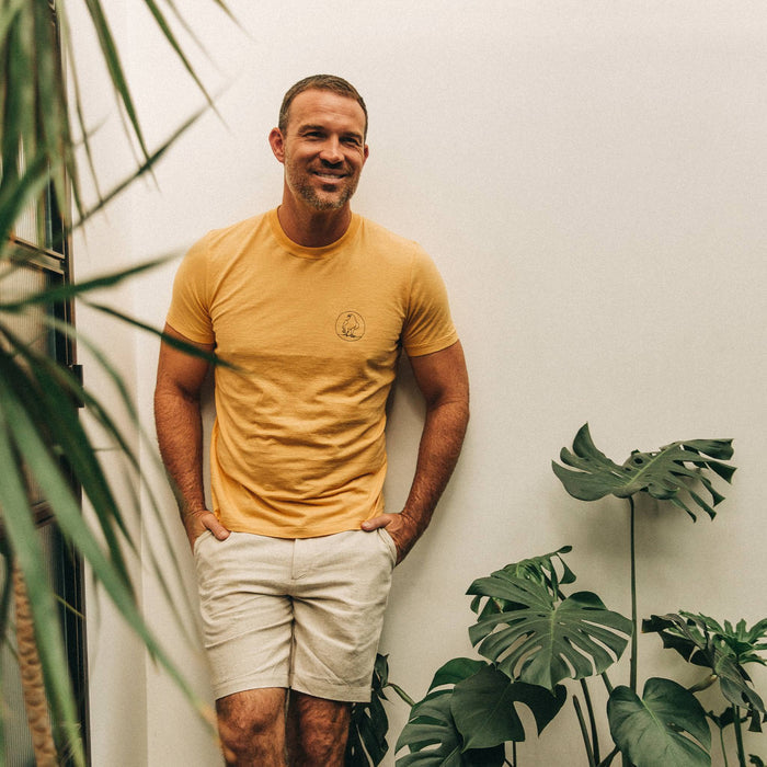 fit model wearing The Cotton Hemp Tee in Canary Eagle, looking right