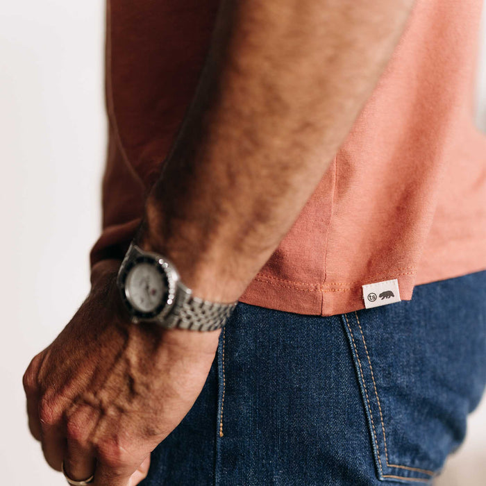 fit model showing off the bottom hem on The Cotton Hemp Tee in Fired Clay