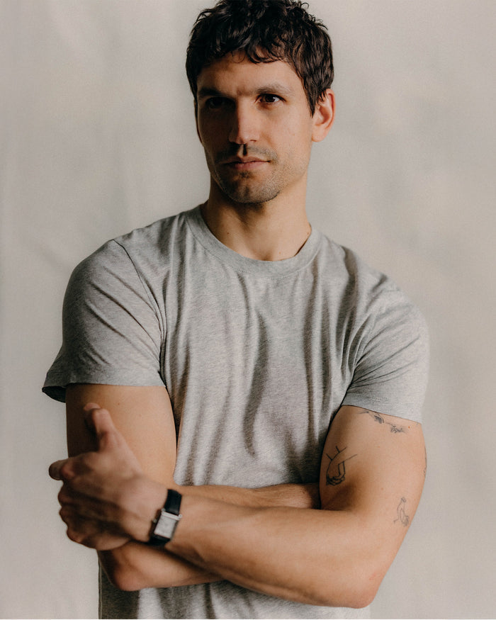 fit model walking in The Cotton Hemp Tee in Heather Grey