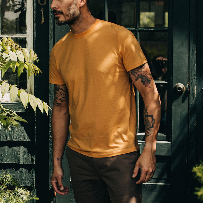 fit model standing in The Cotton Hemp Tee in Mustard