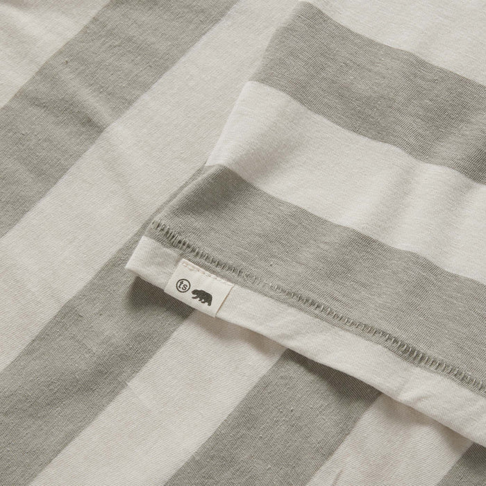 material shot of the TS label on The Cotton Hemp Tee in Natural and Sagebrush Stripe