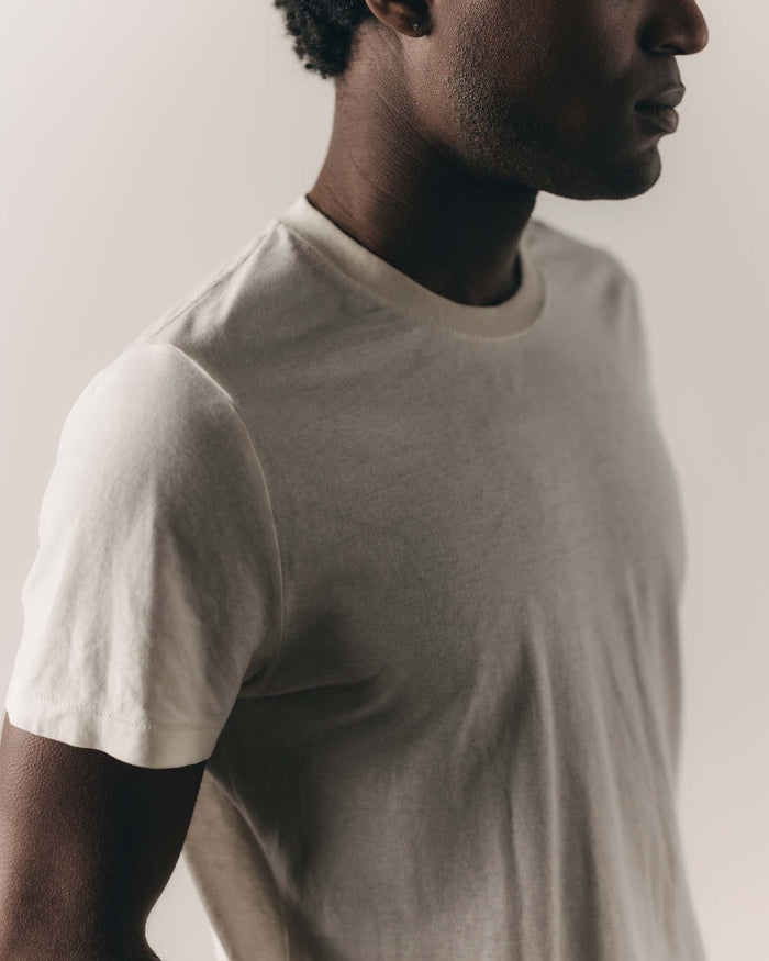 fit model leaning against the wall in The Cotton Hemp Tee in Natural