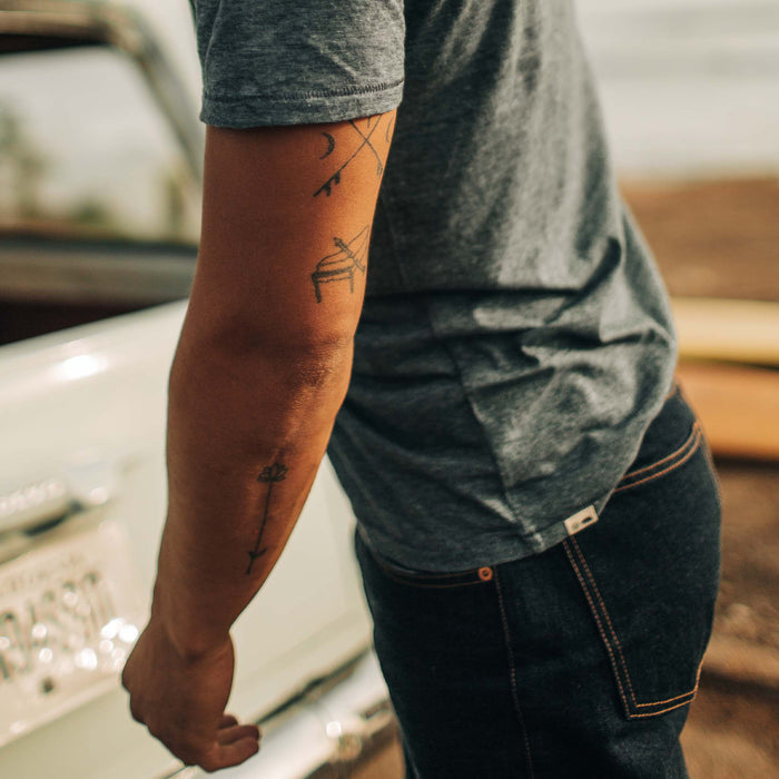 fit model showing the side and back of The Cotton Hemp Tee in Slate and Navy Stripe