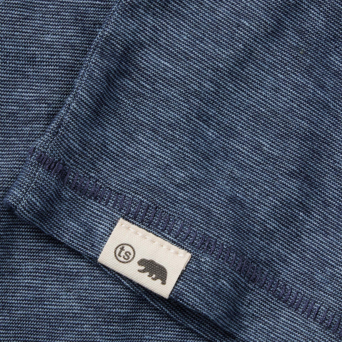material shot of the hem and logo on The Cotton Hemp Tee in Slate and Navy Stripe