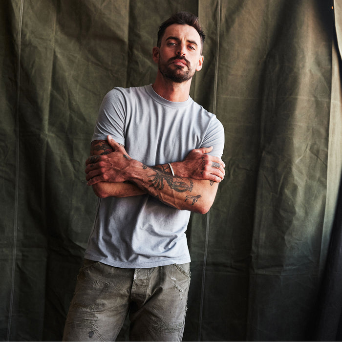 fit model with his arms crossed wearing The Cotton Hemp Tee in Tradewinds