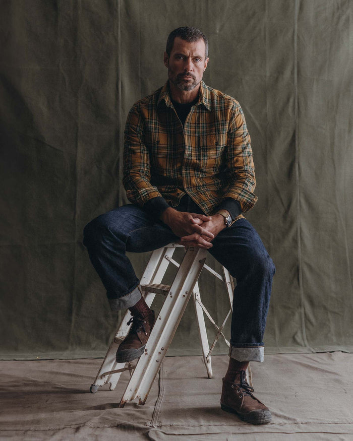 fit model sitting wearing The Craftsman Shirt in Fern Plaid