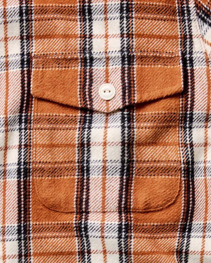 material shot of the pocket with the button on The Crater Shirt in Brick Plaid